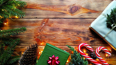 christmas background. a layout of Christmas gifts with fir branches, garlands and Christmas candy...