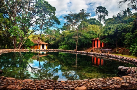A natural swimming pool and colonial style buildings in Villa de Leyva, Colombia の写真素材