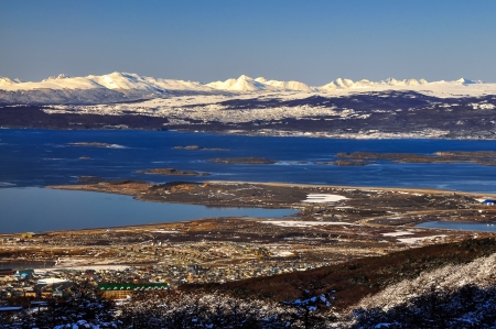 Ushuaia with the Beagle Channel and snow covered mountains behind it の写真素材