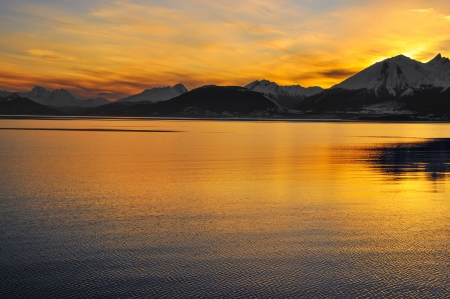 Watching the sunset over the mountains from the Beagle Channel in Tierra del Fuego, Argentina の写真素材
