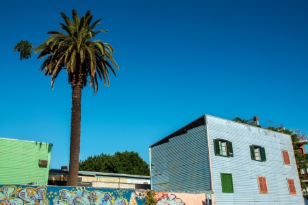 Blue building and palm tree in historic La Boca neighborhood in Buenos Airesのeditorial素材