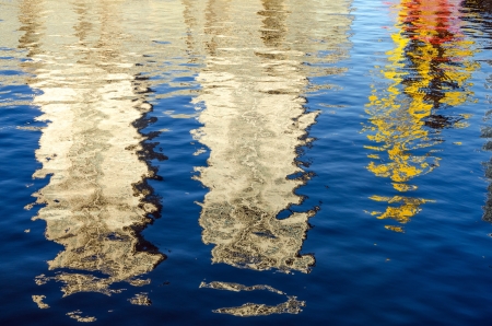 Buildings in the Puerto Madero neighborhood of Buenos Aires, Argentina being reflected in blue waterの写真素材