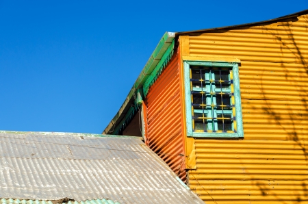 Old orange building set against a blue sky in La Boca neighborhood of Buenos Airesの写真素材