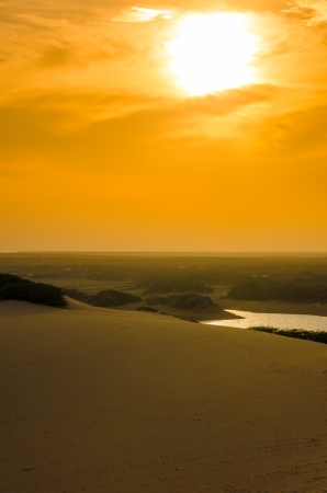 Bright orange sunset over a sand dune in La Guajira, Colombiaの写真素材
