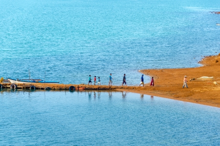 Group of people disembarking from small boats in La Guajira, Colombiaの写真素材