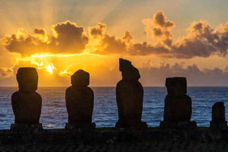 Five moai on Easter Island with the sun setting behind themの写真素材