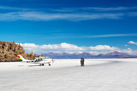 UYUNI, BOLIVIA - JULY 11   Pilots stand next to a Bolivian Air Force after landing on the Uyuni Salt Flats in Uyuni, Bolivia on July 11, 2014のeditorial素材