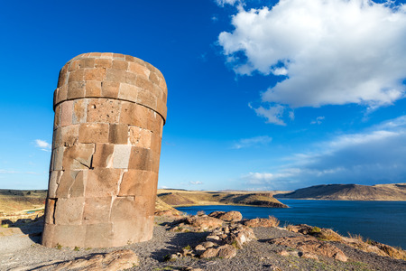Funerary tower at Sillustani with beautiful Lake Umayo in the background near Puno, Peruの写真素材