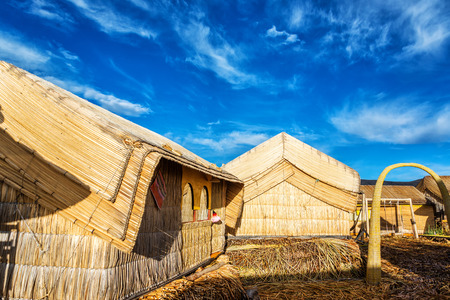 Small houses on Uros floating islands made out of reeds on Lake Titicaca near Puno, Peruのeditorial素材