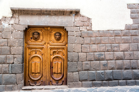 Inca stonework with a beautiful carved wooden door in Cusco, Peruの写真素材