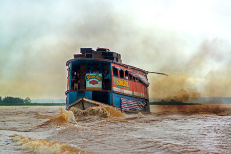 IQUITOS, PERU - MARCH 11: River boat causing pollution in the Amazon River near Iquitos, Peru on March 11, 2015のeditorial素材