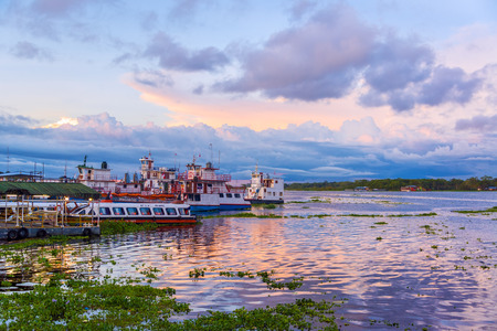 IQUITOS, PERU - MARCH 10: View of the port of Iquitos, Peru at sunset on March 10, 2015.  Iquitos is an Amazonian city with over 500,000 inhabitants.のeditorial素材