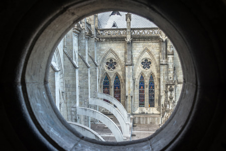 View of the Basilicia in Quito Ecuador seen through a small round windowの写真素材