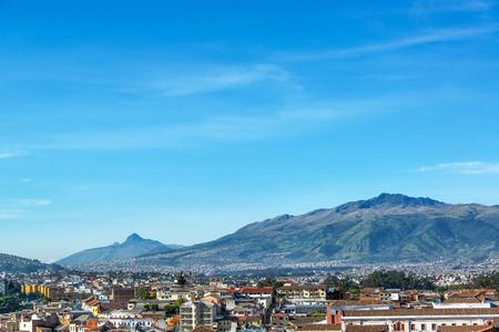 View of Quito Ecuador with large green hills in the backgroundの写真素材