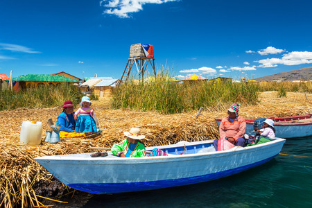 PUNO, PERU - SEPTEMBER 19: Locals conversing on the Uros Floating Islands near Puno, Peru on September 19, 2014のeditorial素材