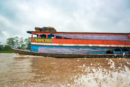 IQUITOS, PERU - MARCH 11: Old boat passing by on the Amazon River near Iquitos, Peru on March 11, 2015のeditorial素材
