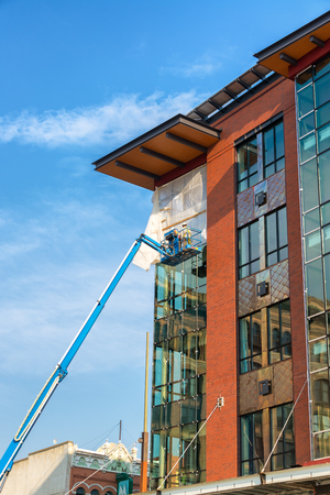 BUTTE, MT - AUGUST 21: Construction workers work on a building in Butte, MT on August 21, 2015のeditorial素材