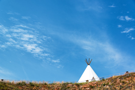 White teepee with a beautiful blue sky near Beulah, Wyomingの写真素材