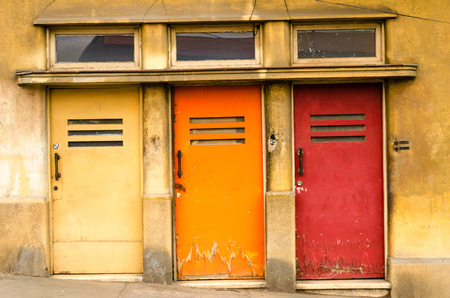Three doors colored yellow, orange, and red in Valparaiso, Chileの写真素材