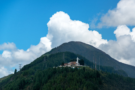 View of Guadalupe Hill with a statue of the Virgin of Guadalupe on it overlooking Bogota, Colombiaの写真素材