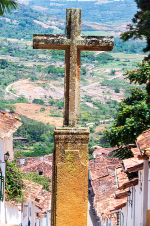 Stone cross with colonial town of Barichara, Colombia belowの写真素材