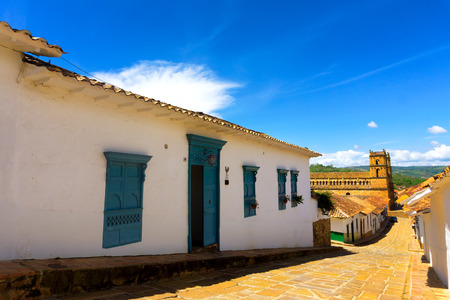 Colonial street in historic Barichara, Colombia with the cathedral in the backgroundの写真素材