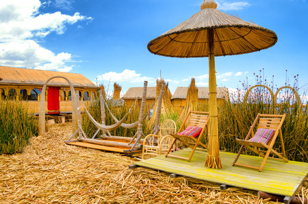 Chairs and hammocks on a man made floating island on Lake Titicaca in Peruの写真素材