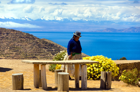 ISLA DEL SOL, BOLIVIA - AUGUST 18:  Indigenous woman on Isla del Sol, Bolivia with the Cordillera Real of the Andes Mountains in the background on August 18, 2014のeditorial素材