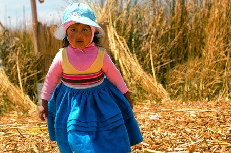 UROS FLOATING ISLANDS, PERU - SEPTEMBER 19: Girl on one of the Uros Floating Islands, Peru on September 19, 2014のeditorial素材