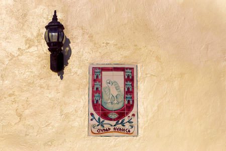 Sign on a wall in Valladolid, Mexico.  The sign says, "Heroic City"の写真素材