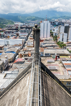 MANIZALES, COLOMBIA - MAY 30: Statue on a cathedral with a cityscape view in Manizales, Colombia on May 30, 2016のeditorial素材