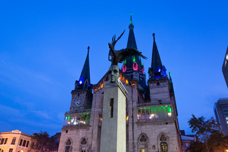 View of the Bolivar Condor statue and cathedral in Manizales, Colombia at nightの写真素材