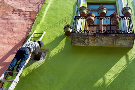 PUEBLA, MEXICO - MARCH 2: Man works on a building in Puebla, Mexico on March 2, 2017のeditorial素材