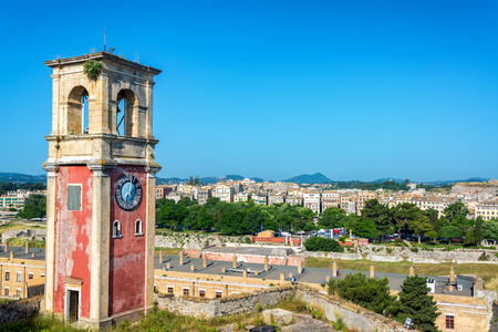 Clock tower in the Old Fortress of Corfu, Greece with a cityscape in the backgroundのeditorial素材