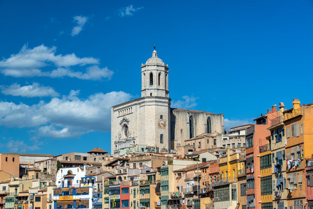 Girona Cathedral rising above colorful buildings in Girona, Spainの写真素材