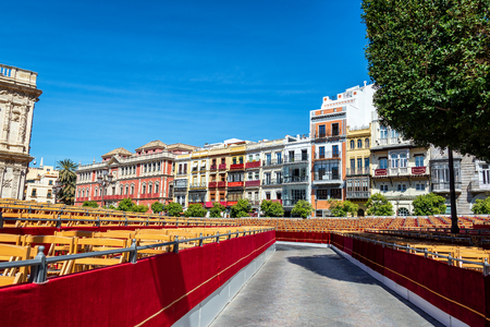 Outdoor seating near the cathedral set up for the arrival of Holy Week processions in Seville, Spainの写真素材