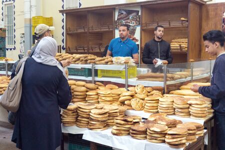 TUNIS, TUNISIA- APRIL 4: Traditional bakery with customers in marketplace in Tunis, Tunisia on April 4, 2018のeditorial素材