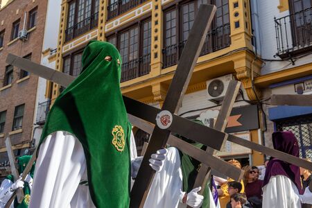 SEVILLE, SPAIN - MARCH 25: Hooded people with crosses in a Holy Week procession in Seville, Spain on March 25, 2018のeditorial素材