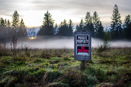 Private property sign on a foggy fieldの写真素材