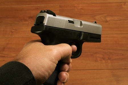 Close up isolated image of male holding pistolの写真素材