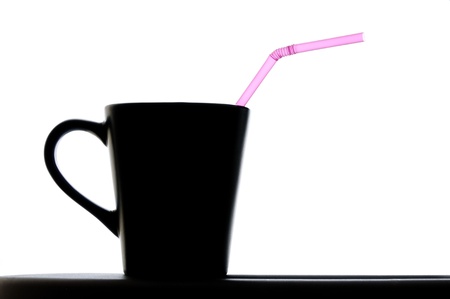 Close up isolated image of coffee cup with pink strawの写真素材