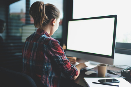 a young casual dressed modern student is looking for a job to practice after completing her studies at the university. a professional IT specialist uploading new content to the website. Blank screenの写真素材
