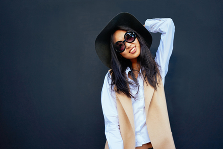 attractive asian young woman smiling isolated on black background with copy space for your text or design.の写真素材