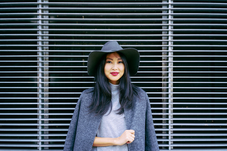 Attractive young Asian girl posing on a industrial backgroundの写真素材