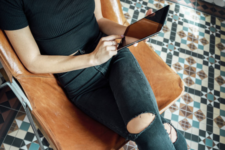 Young women using digital tablet in a vintage interiorの写真素材
