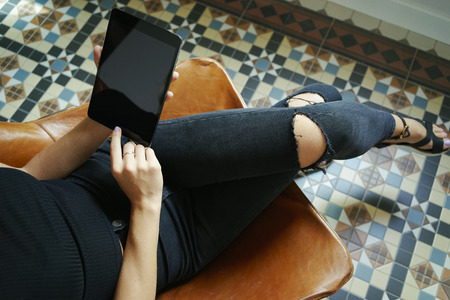 Young female using digital tablet in a vintage interiorの写真素材