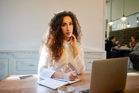 Young attractive business woman holds a job interview in a cafe during the lunch breakの写真素材