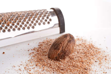 Fresh ground nutmeg with a whole seed grater の写真素材
