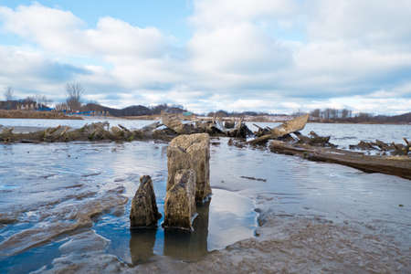 Part of the hull of the  125 year old, 290-foot wooden steamer Aurora, lay in the Grand River  near...