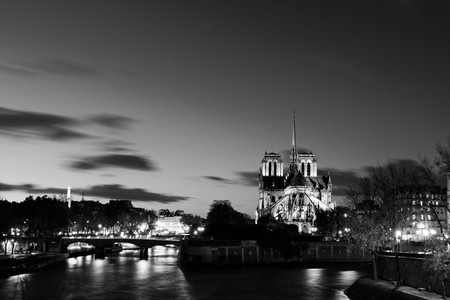 Notre dame de Paris by night and the seine river in the city of Paris in franceの写真素材
